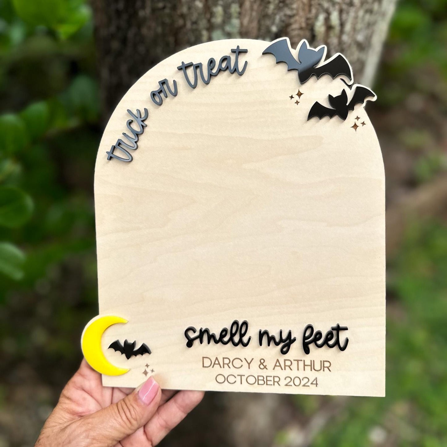 Detail of the 3D acrylic bats and the engraved custom name and date section on the footprint board.