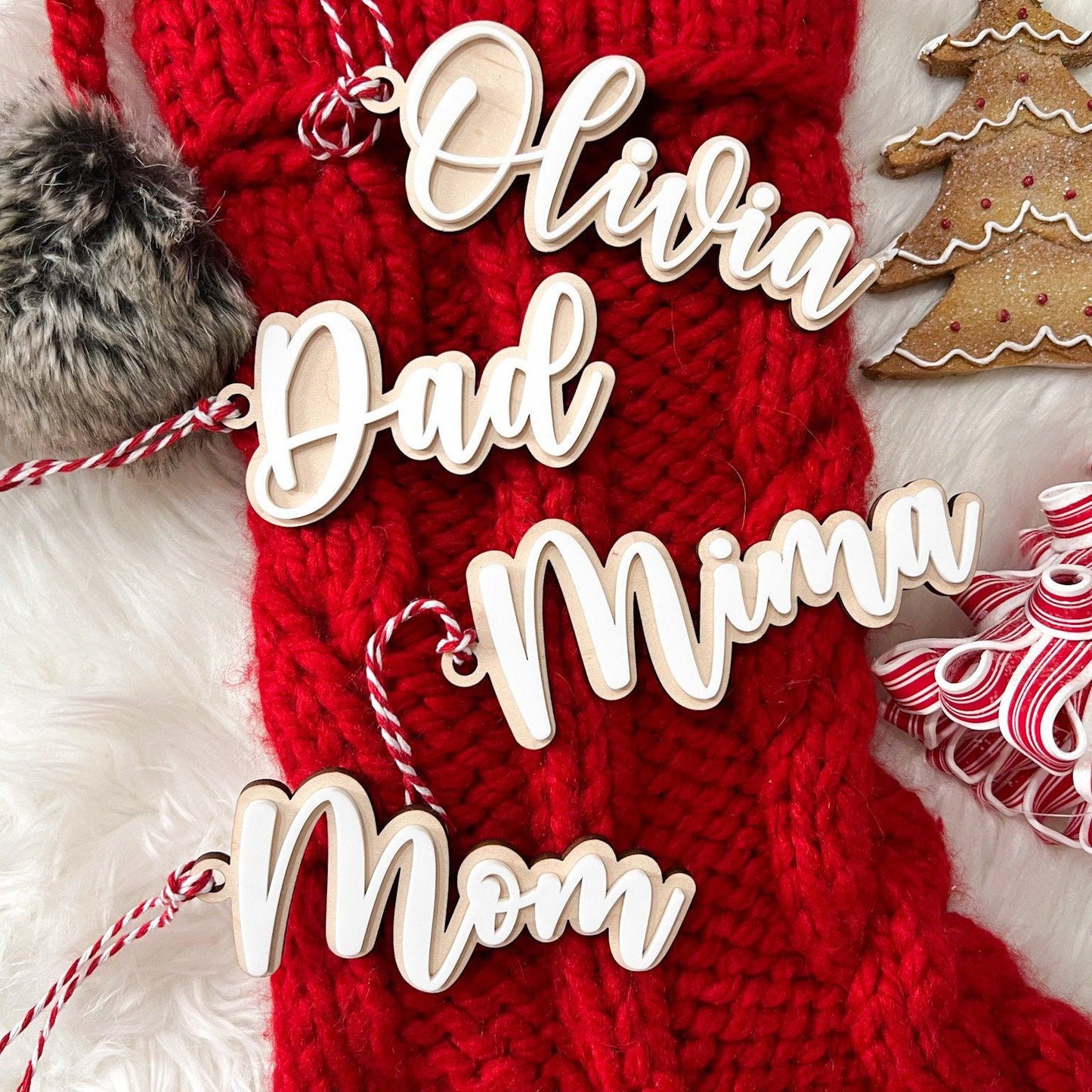 Group shot of several Personalized 3D Acrylic Stocking Tags (e.g., "Dad," "Mom," "Olivia") showcasing the layered depth and different names.