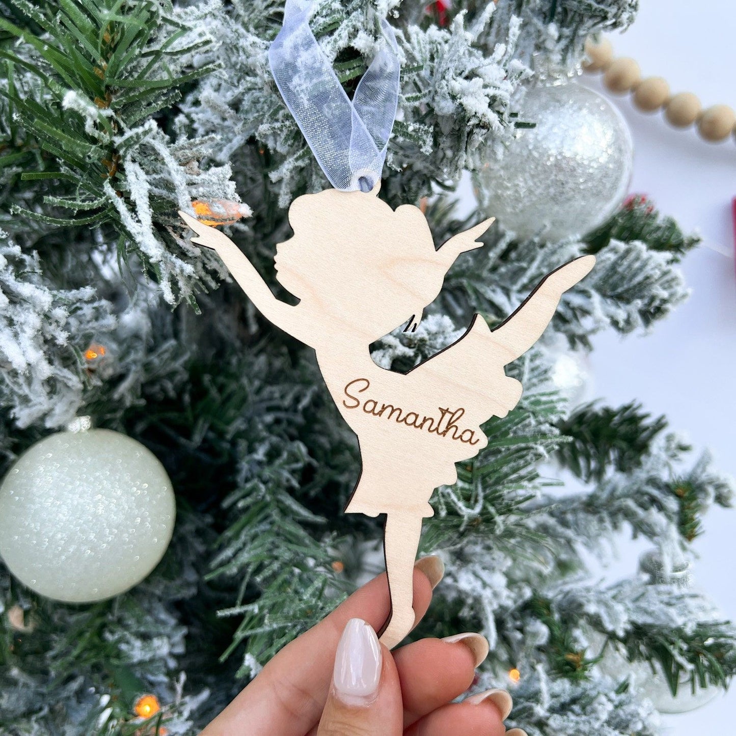 Close-up of the Dancer Keepsake showing the natural grain of the maple plywood and the laser-cut Leg Up Pose silhouette.