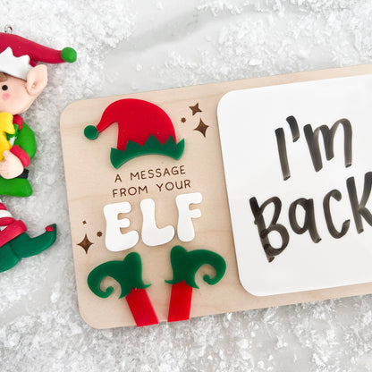 Dry Erase Elf Message Board Prop showing a written message, featuring the 3D acrylic red and green elf feet detail.