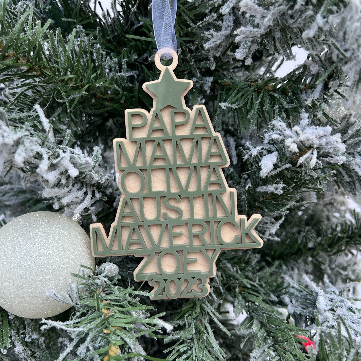 Close-up of the base of the Custom Family Tree Ornament, showing the layered acrylic names and year detail at the bottom.