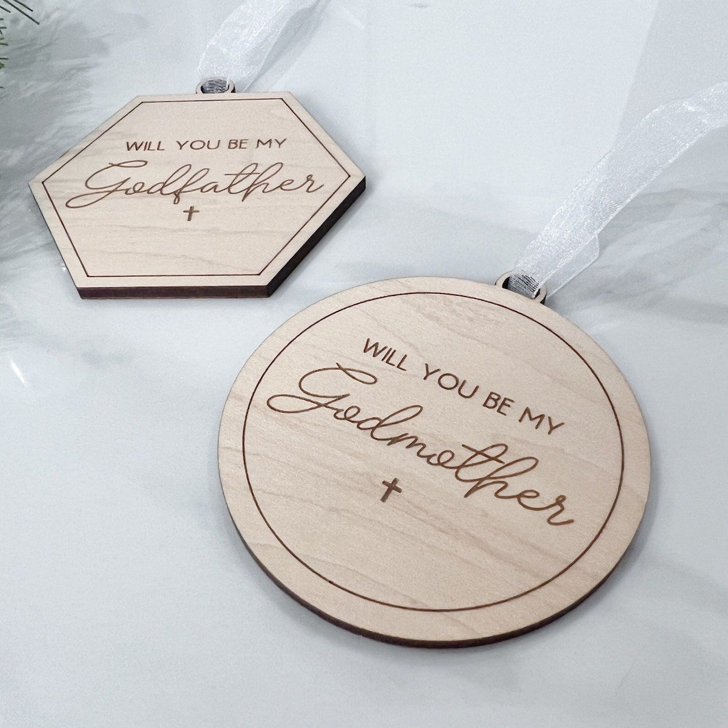 Close-up of the round and hexagonal custom wooden ornaments made from 1/4 inch maple plywood, designed as a sentimental christening gift.