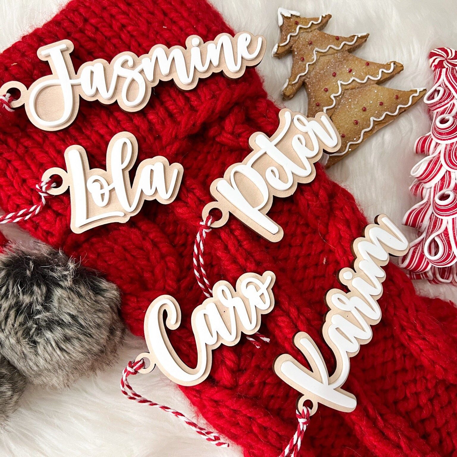 Lifestyle shot of the tags being used as Custom Christmas Gift Identifiers tied to wrapped presents under a tree.