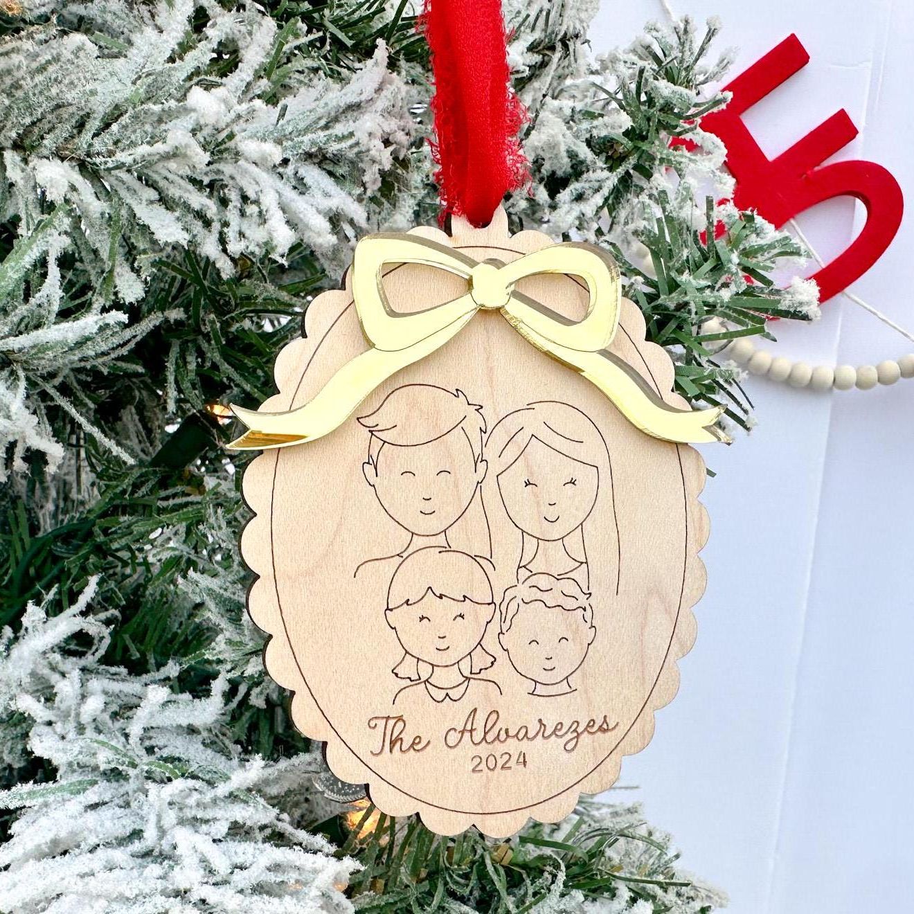 Detail of the Custom Family Ornament showing the crisp laser engraving of the wood and the 3D layered bow accent on the maple plywood base.