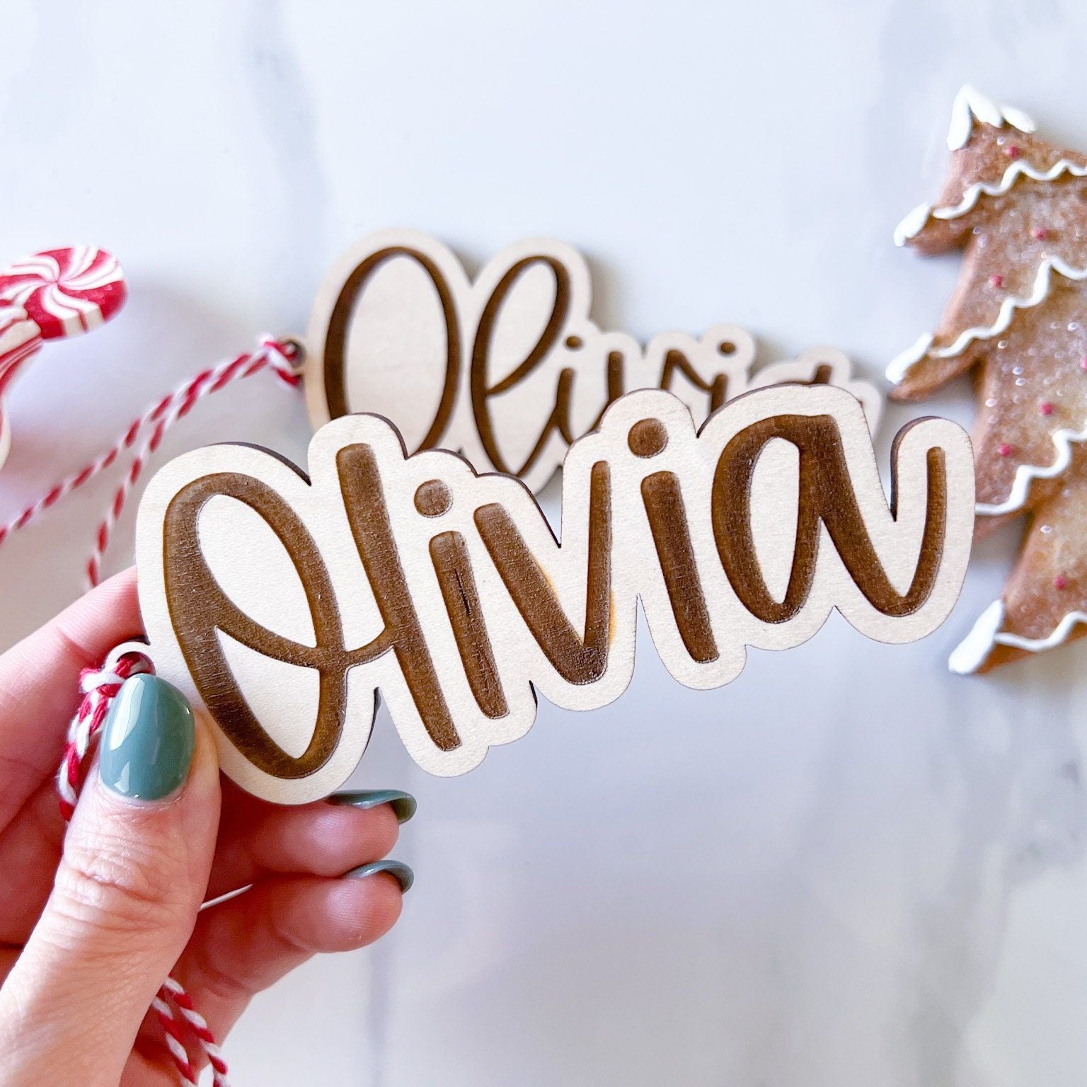 Close-up of the Wooden Name Ornament showing the clean block font style and the maple plywood texture.