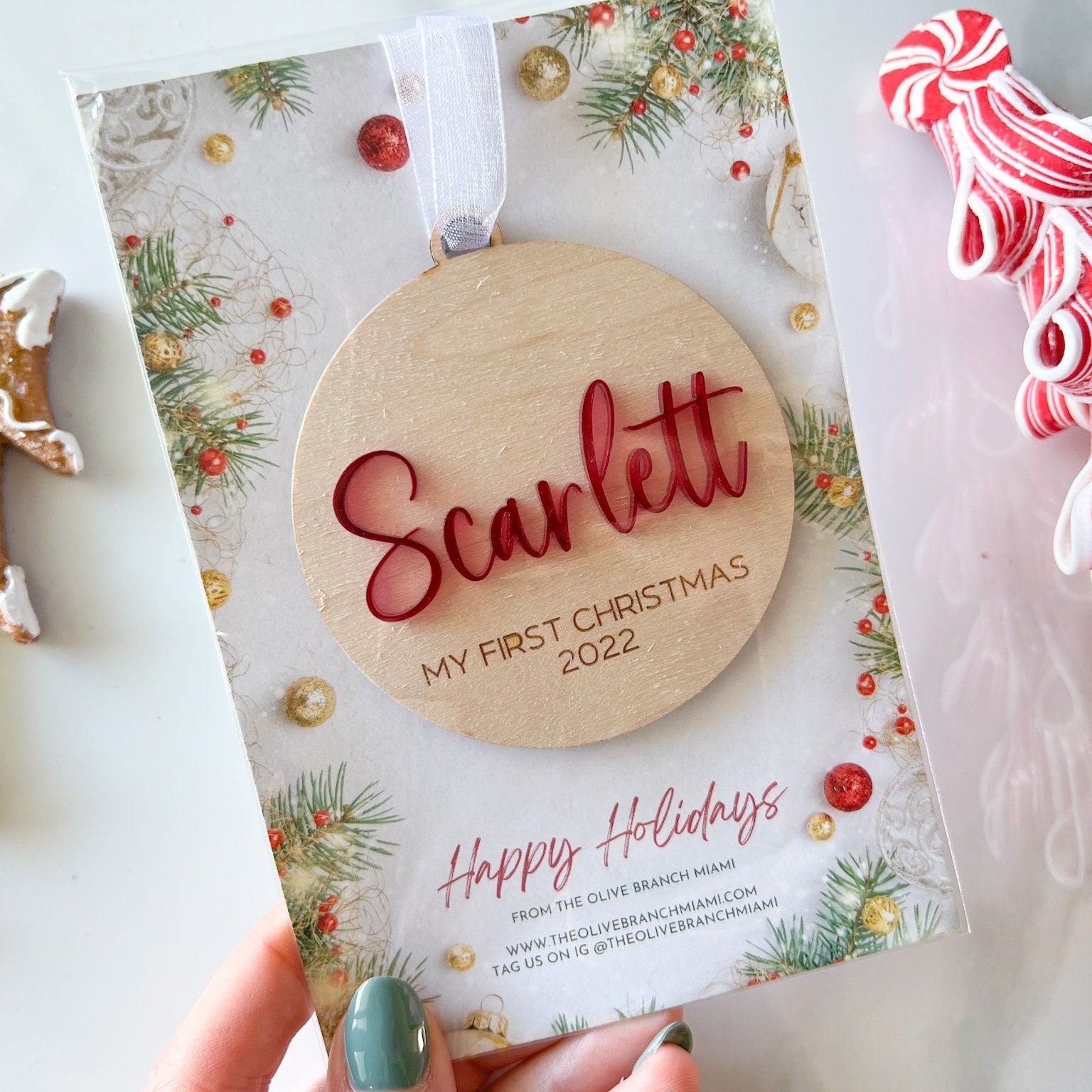 Close-up of the Custom Keepsake Ornament showing the layered 3D acrylic name ("Scarlett" in red) and the detailed laser-engraved year.