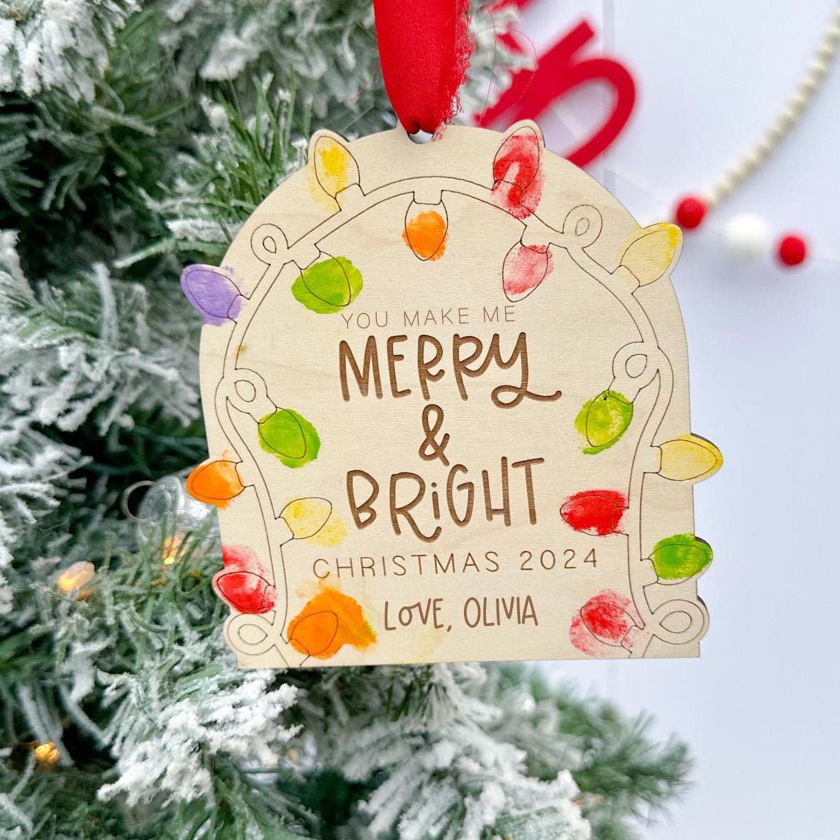 DIY Fingerprint Christmas Ornament Blank engraved with "Merry and Bright", showing the empty light sockets ready for kids' finger paint.