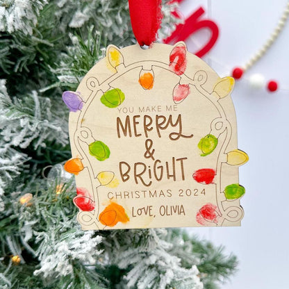 DIY Fingerprint Christmas Ornament Blank engraved with "Merry and Bright", showing the empty light sockets ready for kids' finger paint.