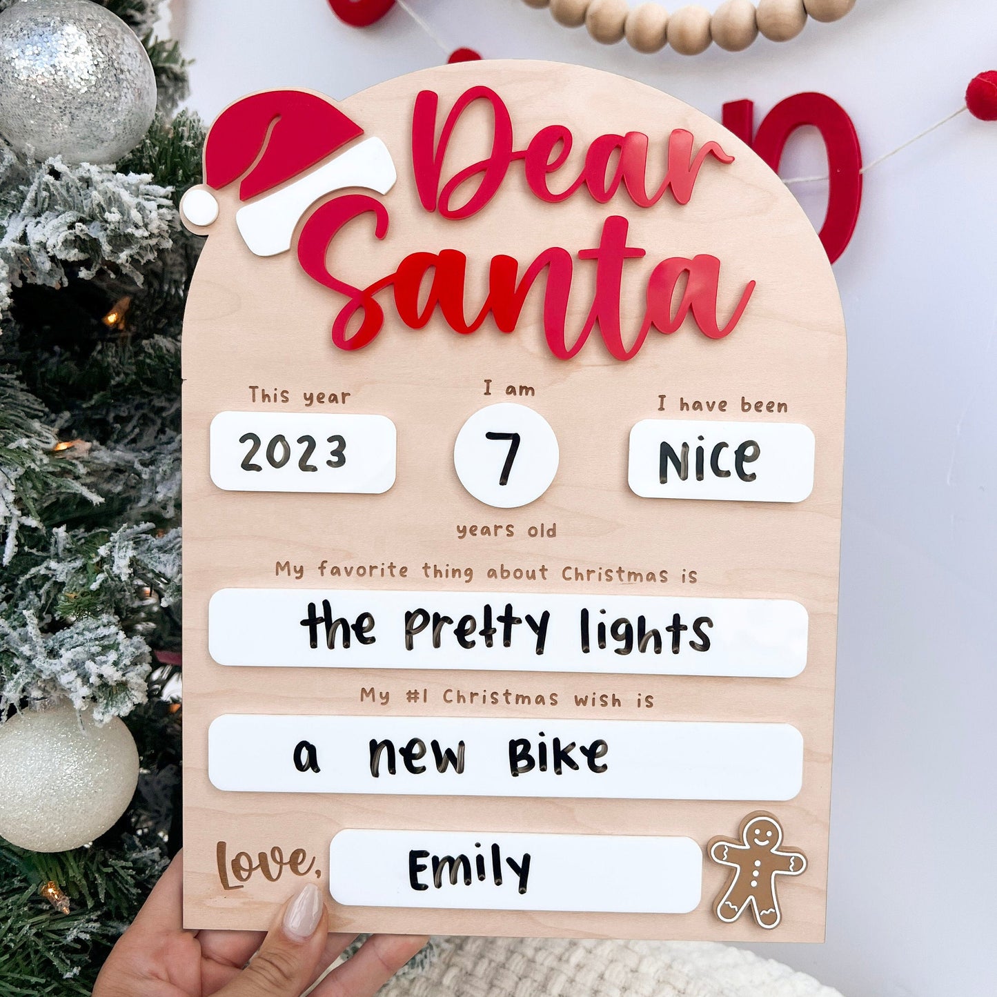 Parent or child writing on the Wooden Dry Erase Board with a marker, emphasizing the interactive Christmas activity aspect.