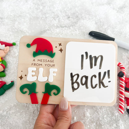 Dry Erase Elf Message Board Prop showing a written message, featuring the 3D acrylic red and green elf feet detail.