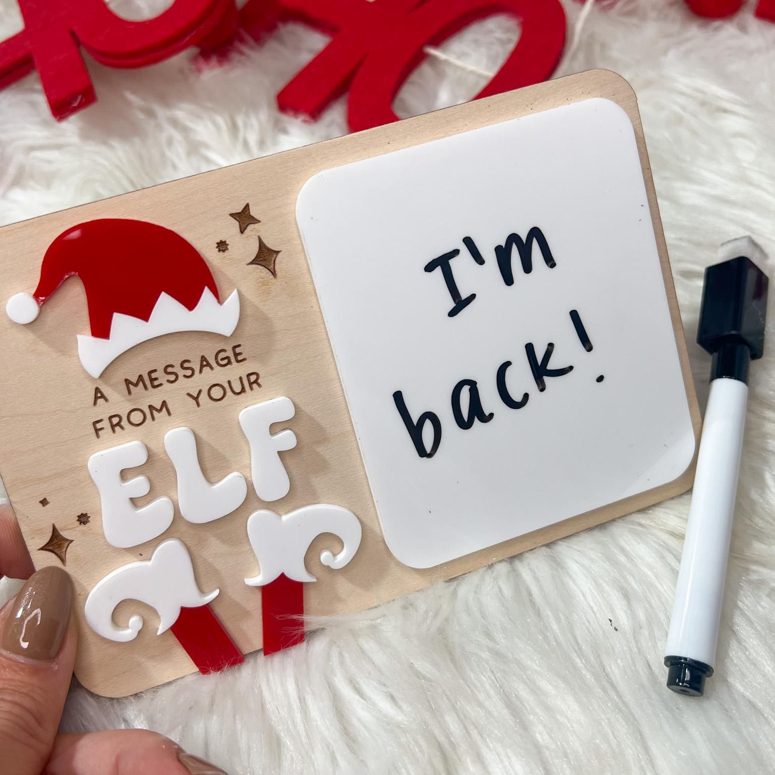 Hand writing a message on the Daily Elf Message Board, emphasizing the interactive and custom message capability.