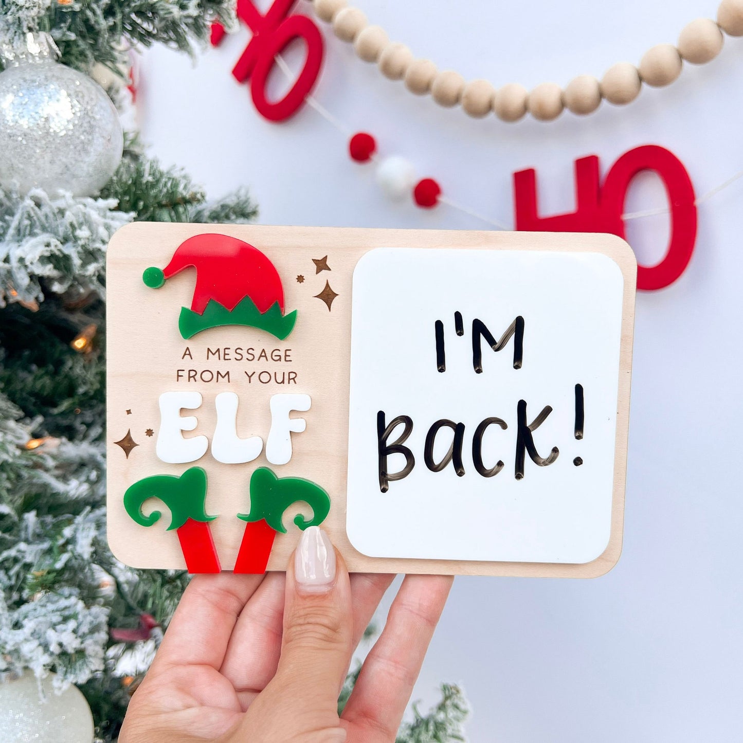 Dry Erase Elf Message Board Prop showing a written message, featuring the 3D acrylic red and green elf feet detail.