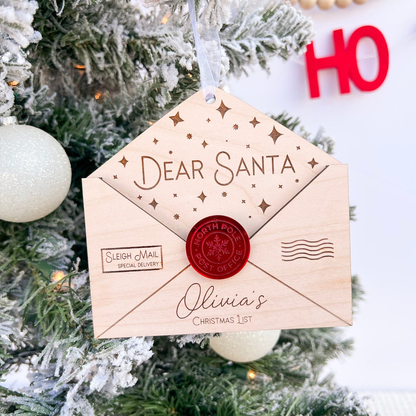 Personalized Family Heirloom shown against a festive holiday background, emphasizing the ornament's 4.9-inch size.