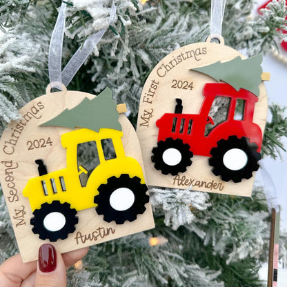 Two Tractor Ornaments demonstrating the difference between the "My First Christmas" and the "My Second Christmas" custom sayings in the arch.