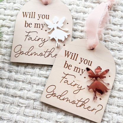Two Fairy Godmother Proposal Ornaments side-by-side, showcasing different acrylic fairy color options (e.g., silver mirror and white).