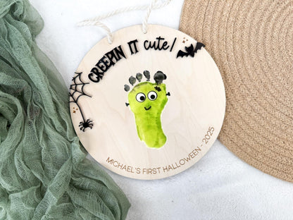 Lifestyle view of the Halloween Footprint Sign styled with seasonal decorations and baby photo props.