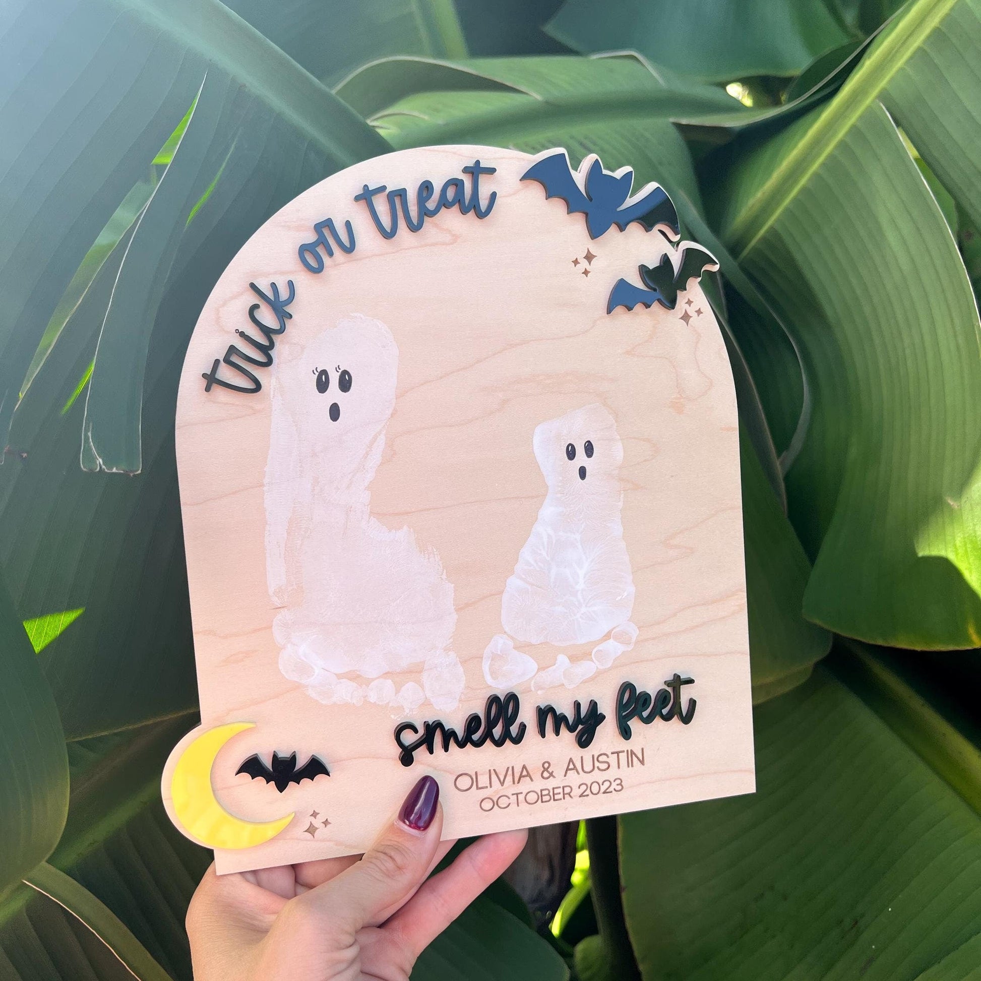 DIY Footprint Ghost Board with two white child footprints on maple plywood and 3D acrylic text