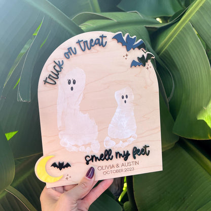 DIY Footprint Ghost Board with two white child footprints on maple plywood and 3D acrylic text