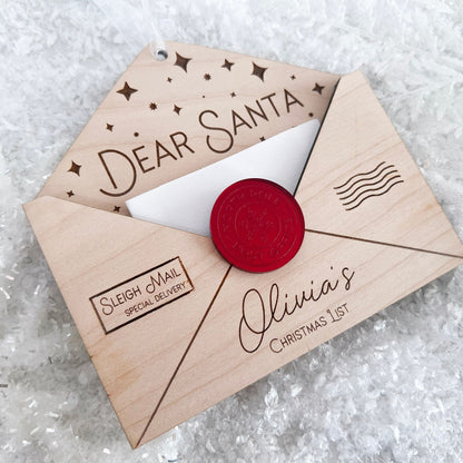 Close-up of the Engraved Envelope Ornament detailing the child's name and the layered acrylic seal accent.