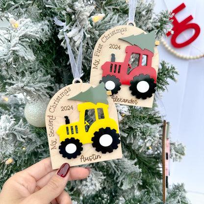 Two Tractor Ornaments demonstrating the difference between the "My First Christmas" and the "My Second Christmas" custom sayings in the arch.