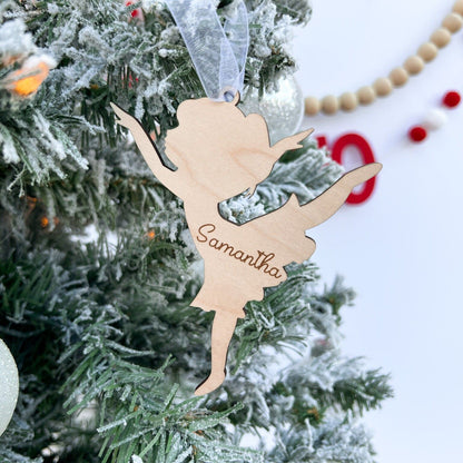 Detail shot of the personalized Dancer Ornament showing the crisp engraved script name and the laser-cut edges of the wood.