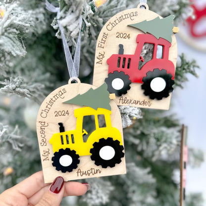 Two Tractor Ornaments demonstrating the difference between the "My First Christmas" and the "My Second Christmas" custom sayings in the arch.