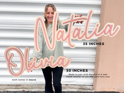 Wooden name signs for nursery or kids room. Done in a script font with in amauve color. "Natalia" is 35 inches, and "Olivia" is 30 inches.