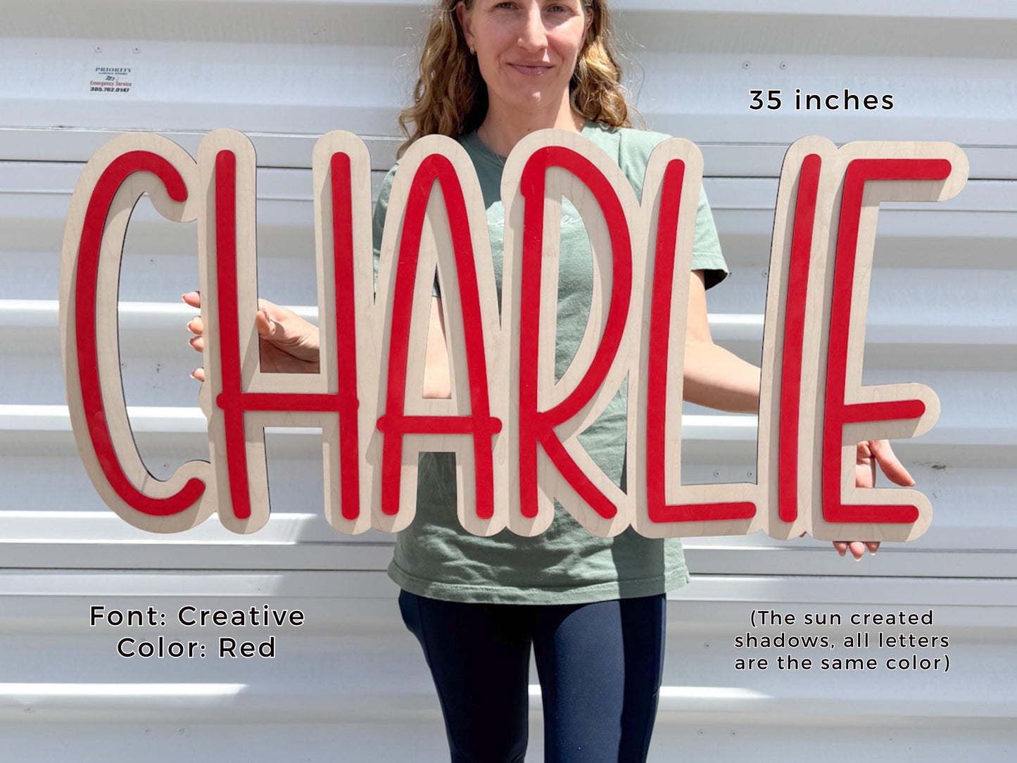 Personalized nursery Wooden sign spelling "CHARLIE" in red and natural wood. The sign is 35 inches long and features a creative font. The text "Font: Creative Color: Red" is also visible.