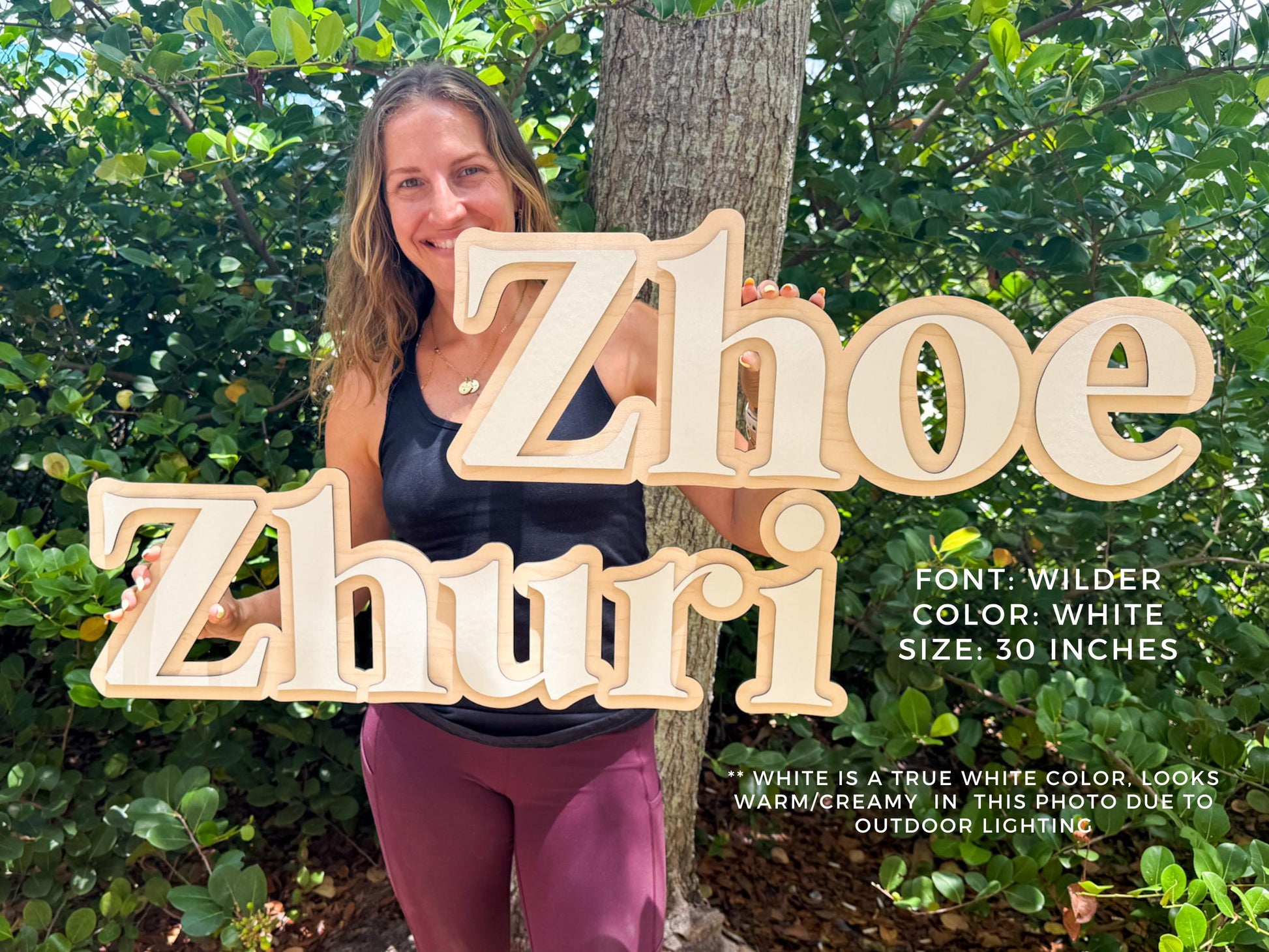 Baby nursery personalized name sign. Wooden name signs, "Zhoe" and "Zhuri", in a Wilder font with a white color. Each sign is 30 inches in size. The signs have a layered design with a natural wood and white color scheme. The text "FONT: WILDER COLOR: WHITE SIZE: 30 INCHES" is also visible.